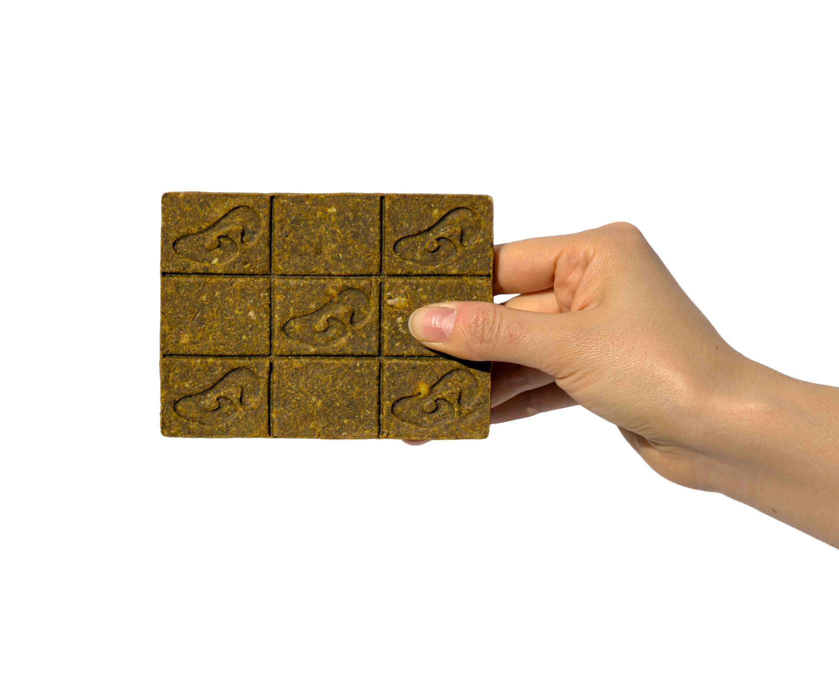 A hand holds the real nine-square topper, with the wrist visible against pale green.